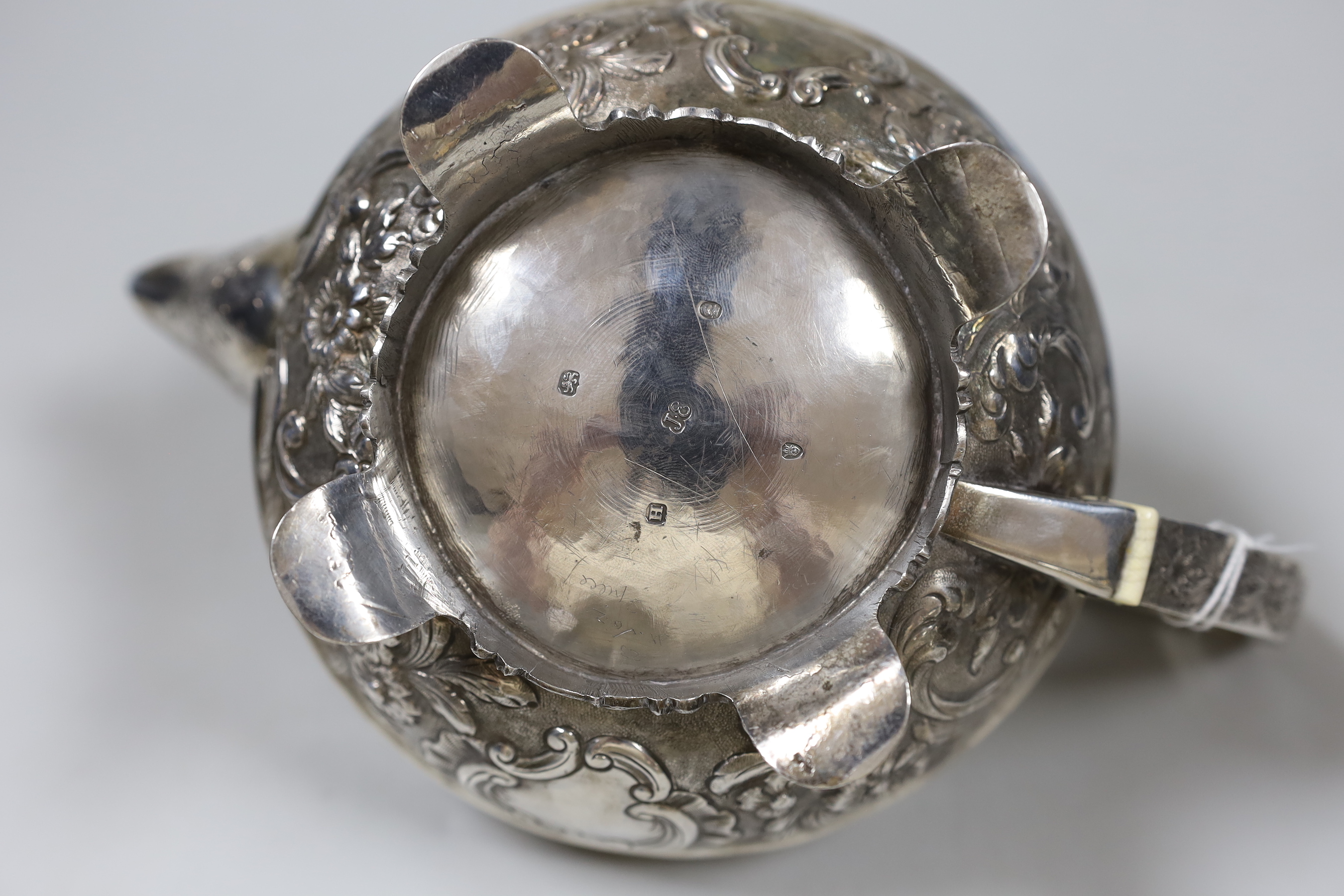 A George III engraved silver squat circular teapot, with foliate decoration and rose finial, by John Emes, London, 1803, gross weight 24.8oz. (See lot 868 for a near matching cream and sugar bowl). Ivory submission refer